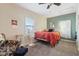 Bright bedroom with carpet, bed, ceiling fan, and stylish armchair at 1390 Greenfield Ave, Noblesville, IN 46060