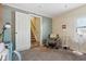 Bright bedroom showcasing a view towards the staircase, a decorative chair, and ambient lighting at 1390 Greenfield Ave, Noblesville, IN 46060