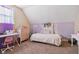 Bright bedroom with a plush bed, lilac accent wall, and whimsical decor at 1390 Greenfield Ave, Noblesville, IN 46060
