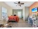 Bright bedroom with modern decor, comfortable bed, desk, and a ceiling fan at 1390 Greenfield Ave, Noblesville, IN 46060