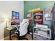 Brightly lit area with desk, wall art, and a white gaming chair at 1390 Greenfield Ave, Noblesville, IN 46060