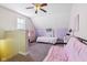 Spacious bedroom featuring a futon, bed and lilac accent wall at 1390 Greenfield Ave, Noblesville, IN 46060