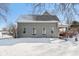 Charming exterior with gray siding, snow-covered yard, and welcoming front porch at 1390 Greenfield Ave, Noblesville, IN 46060