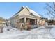 Charming two-story home featuring a cozy front porch and snow-covered front yard at 1390 Greenfield Ave, Noblesville, IN 46060