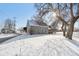 Home exterior in winter with snow-covered yard, highlighting its architecture and neighborhood setting at 1390 Greenfield Ave, Noblesville, IN 46060