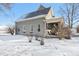 Charming home in winter with snow-covered yard and gray siding, showcasing its curb appeal and seasonal beauty at 1390 Greenfield Ave, Noblesville, IN 46060