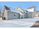 Rear exterior view of a gray house, with a snowy yard at 1390 Greenfield Ave, Noblesville, IN 46060