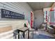 Inviting front porch featuring comfortable seating, a side table, and a charming sign, perfect for gatherings at 1390 Greenfield Ave, Noblesville, IN 46060