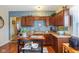 Well-lit kitchen features brown cabinets, a stainless steel sink, and a prep island at 1390 Greenfield Ave, Noblesville, IN 46060