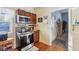 Kitchen features stainless steel appliances, brown cabinets, and an entryway with an exterior door at 1390 Greenfield Ave, Noblesville, IN 46060