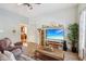 Comfortable living room featuring a large TV, stylish decor, and an open entryway to the kitchen at 1390 Greenfield Ave, Noblesville, IN 46060