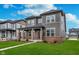 Charming two-story home with gray siding, brick accents, and well-maintained landscaping at 14390 Bishop Birch Pl, Carmel, IN 46032
