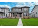 Beautiful two-story home features a manicured lawn, brick accents, and a welcoming front porch at 14390 Bishop Birch Pl, Carmel, IN 46032