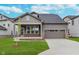 Charming single-Gathering home featuring a well-manicured lawn and a two-car garage on a sunny day at 14390 Bishop Birch Pl, Carmel, IN 46032
