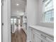 Modern kitchen with white cabinets, marble countertops, and stainless steel appliances at 14390 Bishop Birch Pl, Carmel, IN 46032