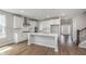 Spacious open-concept kitchen with white cabinets, modern appliances, and stylish island at 14390 Bishop Birch Pl, Carmel, IN 46032