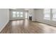 Open-concept living room features a fireplace, luxury vinyl flooring and lots of natural light at 14390 Bishop Birch Pl, Carmel, IN 46032