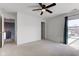 Bright, carpeted bedroom features ceiling fan, closet, and natural light with a peaceful view at 15486 Dusty Trl, Noblesville, IN 46060