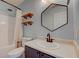 Updated bathroom featuring a single sink vanity, open wood shelves, and shower with tub at 15486 Dusty Trl, Noblesville, IN 46060