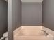 Corner bathtub with white tile and chrome fixtures at 15486 Dusty Trl, Noblesville, IN 46060