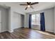 Spacious bedroom featuring wood-look floors, a ceiling fan, window with natural light, and a walk-in closet at 15486 Dusty Trl, Noblesville, IN 46060