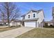 Charming two-story home with a spacious driveway and a well-maintained lawn on a sunny day at 15486 Dusty Trl, Noblesville, IN 46060