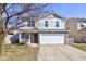 Inviting two-story home featuring a two-car garage, and a welcoming front porch at 15486 Dusty Trl, Noblesville, IN 46060