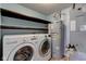 Functional laundry area equipped with modern appliances and ample storage shelves and equipment at 15486 Dusty Trl, Noblesville, IN 46060