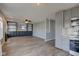 Open-concept living room and kitchen area with built-in shelves and fireplace at 15486 Dusty Trl, Noblesville, IN 46060