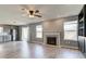 Spacious living area featuring a fireplace, hardwood floors, and seamless integration with the kitchen at 15486 Dusty Trl, Noblesville, IN 46060