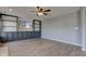 Bright living room with built-in shelving, and hardwood floors and a view of the front yard at 15486 Dusty Trl, Noblesville, IN 46060
