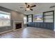 Comfortable living room featuring a fireplace, custom built-in shelving, and ample natural light at 15486 Dusty Trl, Noblesville, IN 46060