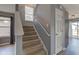 Carpeted stairway with gray walls, white trim, and a side-facing window at 15486 Dusty Trl, Noblesville, IN 46060