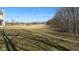 A very large grass backyard surrounded by treelines and other homes at 1588 E Us Highway 136, Hillsboro, IN 47949