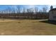 Expansive backyard with potential for outdoor activities, bordered by mature trees at 1588 E Us Highway 136, Hillsboro, IN 47949