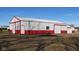 Exterior view of large barn building with red and white accents and a sliding door at 1588 E Us Highway 136, Hillsboro, IN 47949