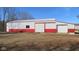 Exterior view of large barn building with red and white accents and a garage door at 1588 E Us Highway 136, Hillsboro, IN 47949