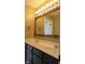 Bathroom featuring a dual sink vanity with warm lighting above the rustic mirror at 1588 E Us Highway 136, Hillsboro, IN 47949