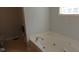 Bright bathroom featuring a soaking tub, and a separate shower area at 1588 E Us Highway 136, Hillsboro, IN 47949