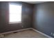 Bedroom with window and neutral carpet offering natural light and ample space at 1588 E Us Highway 136, Hillsboro, IN 47949