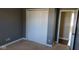 Bedroom with large closet and gray walls leading to a tan-colored bedroom at 1588 E Us Highway 136, Hillsboro, IN 47949