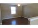 Bonus Room featuring dark wood laminate flooring, a ceiling fan and a window at 1588 E Us Highway 136, Hillsboro, IN 47949