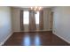 Dining Room showcasing wood laminate floors and natural light from two windows at 1588 E Us Highway 136, Hillsboro, IN 47949