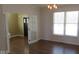 Bright dining room featuring hardwood floors, a large window, and glass french doors at 1588 E Us Highway 136, Hillsboro, IN 47949