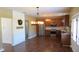 Open-concept kitchen with stainless steel appliances, wood cabinets, hardwood floors, and modern lighting at 1588 E Us Highway 136, Hillsboro, IN 47949