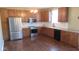 Traditional style kitchen featuring stainless steel appliances, wood cabinets and hardwood floors at 1588 E Us Highway 136, Hillsboro, IN 47949
