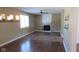 Living room with fireplace, hardwood flooring, a ceiling fan, and natural light from large windows at 1588 E Us Highway 136, Hillsboro, IN 47949