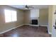 Inviting living room with a fireplace, modern ceiling fan and hardwood flooring at 1588 E Us Highway 136, Hillsboro, IN 47949