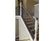 Close up of staircase showing dark metal spindles and wood railing at 1588 E Us Highway 136, Hillsboro, IN 47949