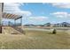 Backyard with a wooden pergola overlooking a pond and neighborhood at 15969 Sonnet Park Ln, Westfield, IN 46074